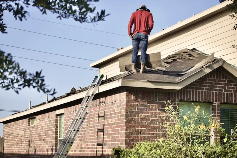 Professional roofer working on a residential roof in Randall Ridge